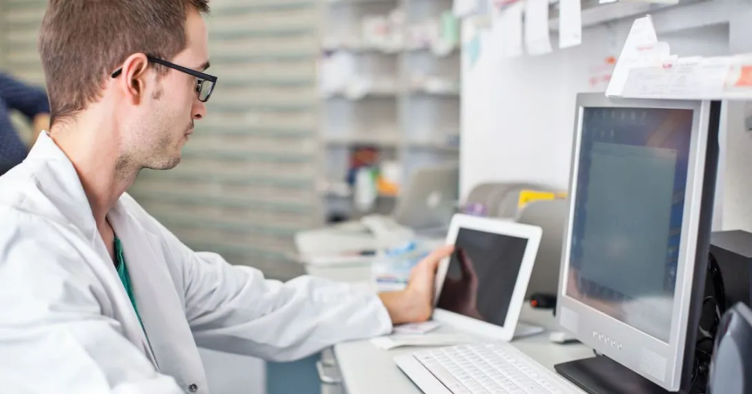 
  Healthcare provider looking at two computers
